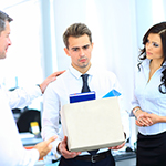 constructive_dismissal_squareimage An employee worries about constructive dismissal as he carries his stuff while being consoled by his employer and two colleagues over the loss of his position.